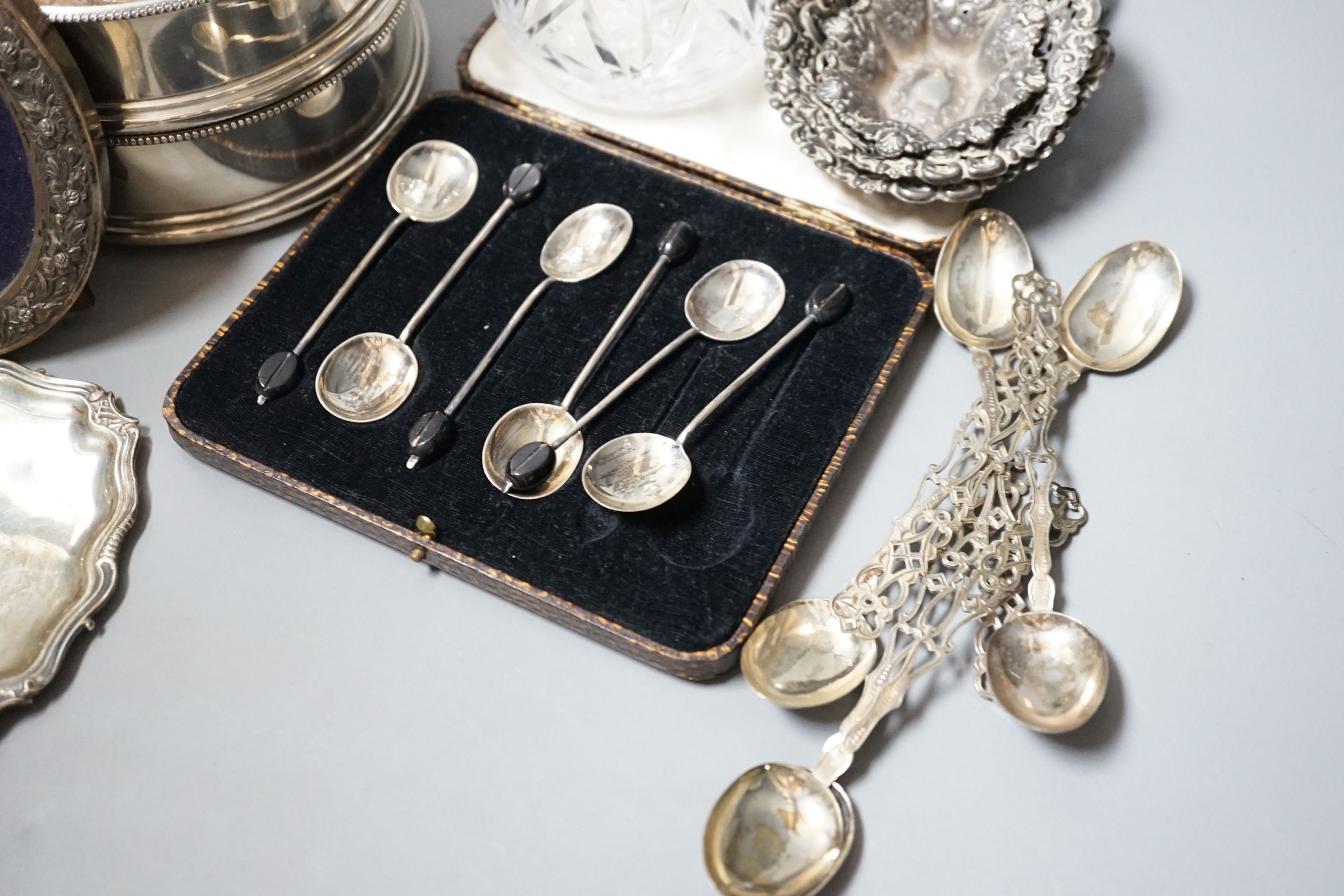 Mixed small silver including a pair of modern silver mounted wine coasters, 12.6cm, two silver mounted photograph frames, silver dish by William Comyns, three silver bonbon dishes, two sets of six silver teaspoons, a sil